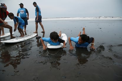 Las clases son gratuitas, y los nicos requisitos para los alumnos es que tengan entre 4 y 10 a?os y que estn dentro del nivel uno de autismo. En la imagen, una instructora ense?a a un ni?o a bracear y patalear sobre la tabla de surf.