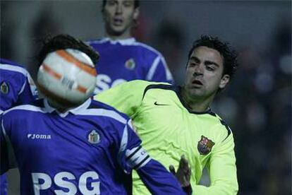 Xavi, a la derecha, acosa a un jugador del Getafe.