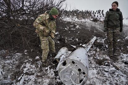  On the right, Vira, 39, stands alongside the remains of the missile that was shot down on the outskirts of Kyiv on Friday, December 16.