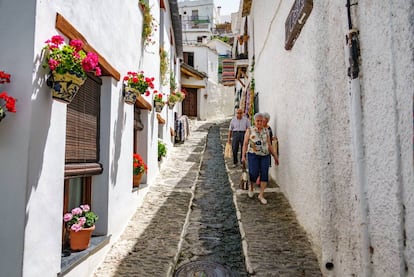 La arquitectura de este pueblo ubicado en la vertiente sur de Sierra Nevada conserva la esencia de su pasado bereber. Casas de piedra encaladas con sus característicos ‘terraos’ (tejados planos cubiertos de launa) apelotonadas en estrechas y sinuosas callejuelas dispuestas sobre la pendiente del barranco de Poqueira. Inicio de una ruta clásica por la Alpujarra de Granada, es recomendable detenerse y pasear por el barrio Bajo, que conserva sus tradicionales ‘tinaos’ (soportales de acceso a las viviendas), o contemplar las cimas del Veleta y el Mulhacén desde el barrio de los pastores, así como visitar los pueblos, valle arriba, de Bubión y Capileira. Más información: <a href="http://www.turismopampaneira.com/vesp/index.htm" target="_blank">turismopampaneira.com</a>