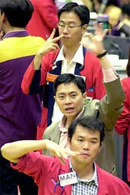Un grupo de corredores de Bolsa, ayer en el mercado de Singapur.