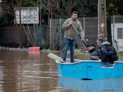 Personas se trasladan en botes por calles inundadas tras el desborde del río Claro, en la ciudad de Talca, Chile.