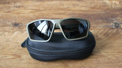 Sports sunglasses on a wooden table.