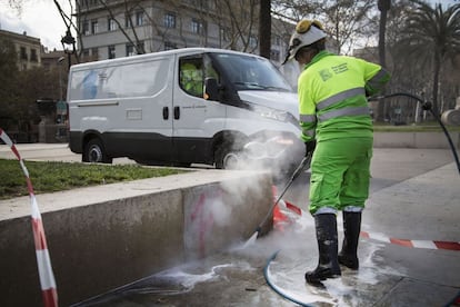 A sanitation worker cleans the streets in Barcelona.