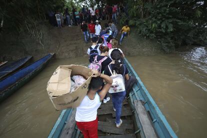 Cerca de 4.000 personas han huido a Colombia por choques armados en Venezuela. En la imagen, venezolanos bajan de un bote en el río Arauca.