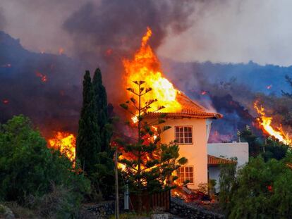 A house burns on Monday in Los Llanos de Aridane after being reached by the lava.