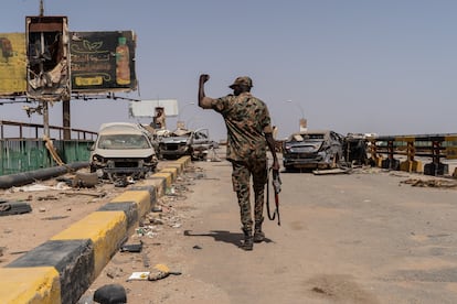 A Sudanese soldier walks across the Shambat Bridge, between Omdurman and the Bahri neighborhood in Khartoum.