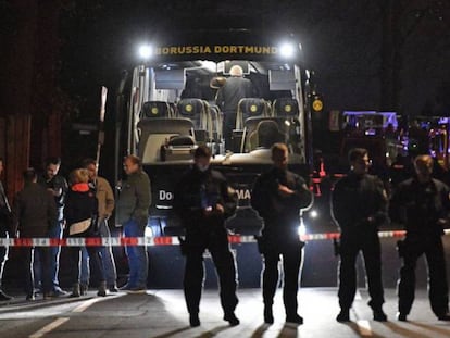 Varios polic&iacute;as, este martes junto al autob&uacute;s del Borussia Dortmund en Dortmund (Alemania). 