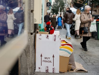 Una persona sin hogar se resguarda del frío con cartones en Madrid.