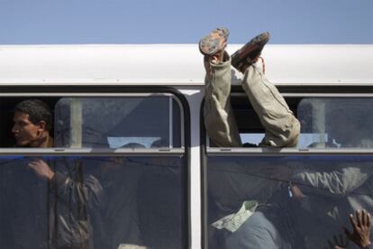 Ciudadanos egipcios que huyeron de la revuelta en Libia a través de Túnez abandonan en autobús el campo de refugiados.