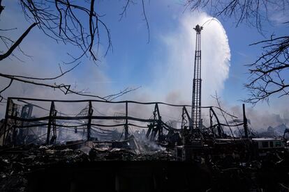 Firefighters pour water on an industrial fire in Richmond, Indiana, April 13, 2023.