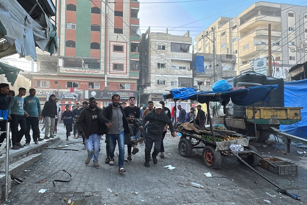 Palestinians carry a wounded man after an Israeli strike on Al-Farooq mosque, amid the Israel-Hamas conflict, in Nuseirat refugee camp, in the central Gaza Strip, November 23, 2024. REUTERS/Khamis Said