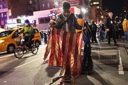 A person holds up a burned American flag during protests in New York City, on Thursday, January 26, 2023.