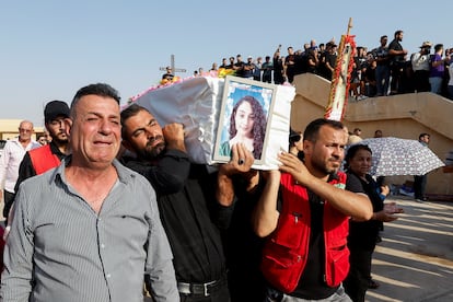 Mourners carry a coffin of a victim of the fatal fire of a wedding celebration, during the funeral in Hamdaniya, Iraq, on September 27, 2023.