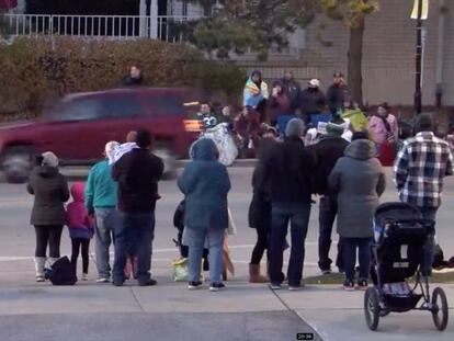 A red SUV speeds past attendees moments before plowing into a crowd at a Christmas parade in Waukesha, Wisconsin, U.S., in this still image taken from a November 21, 2021 social media video. CITY OF WAUKESHA/Facebook/via REUTERS THIS IMAGE HAS BEEN SUPPLIED BY A THIRD PARTY. MANDATORY CREDIT. NO RESALES. NO ARCHIVES.