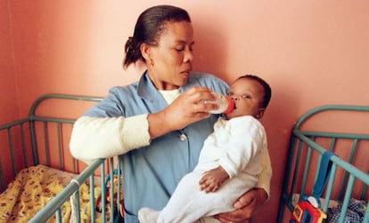 A nurse in Johannesburg feeds an HIV-infected child.