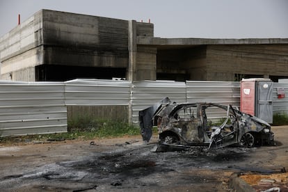 Un vehículo calcinado ante un centro dañado por el lanzamiento de drones por Hezbolá contra Arab al Aramshe, en el norte de Israel, este jueves.