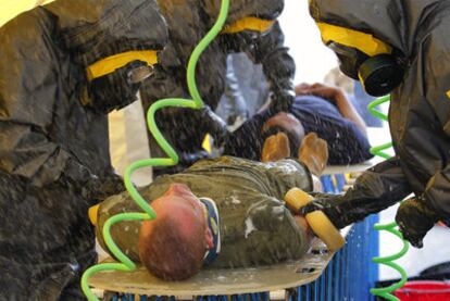 Miembros de un equipo de emergencia realizan un ejercicio de descontaminación en la base aérea de Yokota, en Tokio.