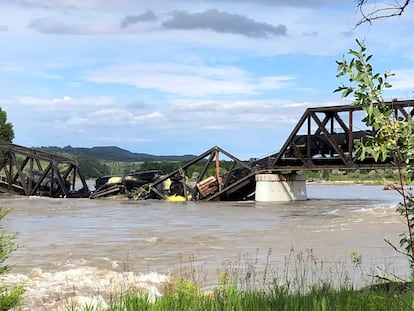 Several train cars are immersed in the Yellowstone River after a bridge collapse near Columbus, Mont., on Saturday, June 24, 2023.