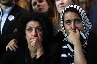 Two women watch the count on election night.