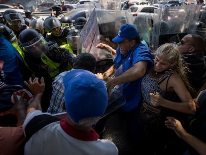 Manifestantes se enfrentan a policías durante una protesta en la que piden mejoras salariales, en Caracas.