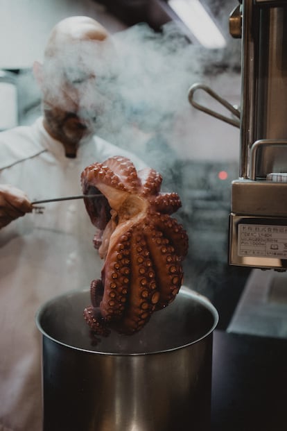 El cocinero Manuel Domínguez, sacando  un pulpo del agua en la cocina de Lúa. Imagen proporcionada por el restaurante.