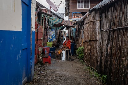 Una mujer mayor afuera de su casa en Cartí Sugdub, donde el espacio entre una casa y otra es mínimo.