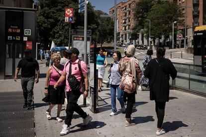 Neighbors in front of the Metro station in the Background neighborhood of Santa Coloma de Gramenet (Barcelona).