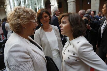 La vicepresidenta del Gobierno, Soraya Sáenz de Santamaría (d), conversa con la alcaldesa de Madrid, Manuela Carmena (i) y la presidenta de la Asamblea de Madrid, Paloma Adrados (c).