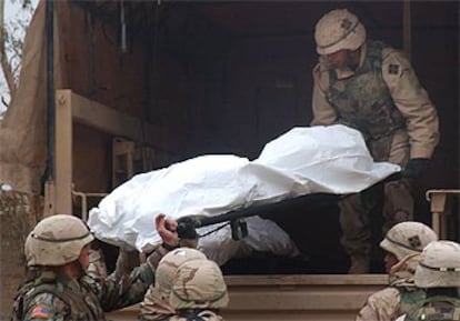Soldados estadounidenses transportan el cadáver de uno de los diplomáticos japoneses, ayer en Tikrit.