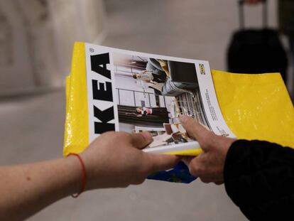 FILE PHOTO: An IKEA worker hands out catalogues at the entrance to an IKEA store in Madrid