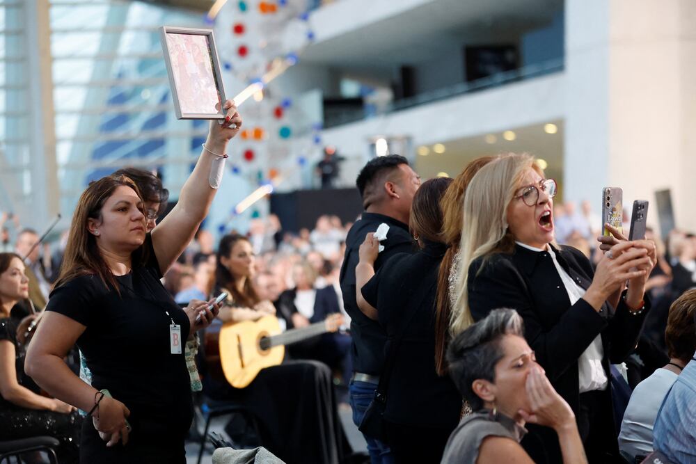 Demonstrators hold pictures of victims and shout on the day of the state funeral in memory of the victims of the floods in Valencia a year ago, at the City of Arts and Sciences in Valencia, Spain, October 29, 2025. REUTERS/Eva Manez