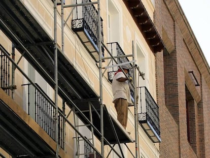 Un hombre trabaja en la rehabilitación de una fachada en Madrid, en una imagen de archivo.