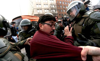 A protestor is arrested in Santiago on Monday.