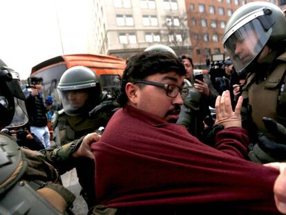 A protestor is arrested in Santiago on Monday.