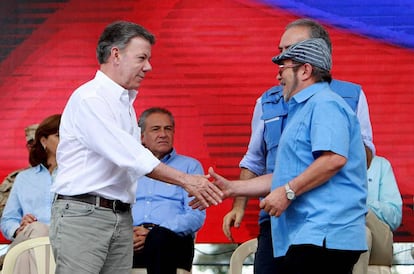 El presidente de Colombia, Juan Manuel Santos (i), estrecha la mano del máximo líder de las FARC, Rodrigo Londoño, alias 'Timochenko' (d), durante la ceremonia de dejación de armas en la zona veredal transitoria de normalización (ZVTN) de Buenavista, también llamada La Guajira en Mesetas, municipio del departamento del Meta (Colombia).