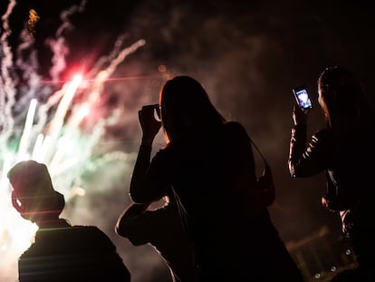 Un grupo de personas graba los fuegos artificales durante una celebracion de Año Nuevo, en Santiago (Chile), en una imagen de archivo.