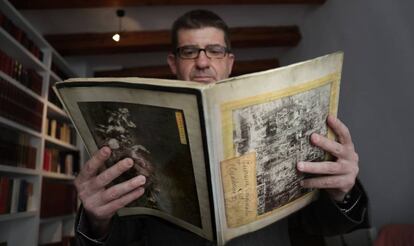 Javier Monjas holding the scrapbook he found at the Rastro market in Madrid.