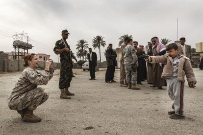 La soldado Megan McLung fotografía al hijo de uno de los líderes suníes portando una pistola. La imagen fue tomada el 6 de diciembre de 2006 en Ramadi (Irak).