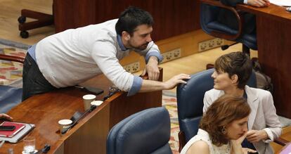 El diputado de Podemos Ramón Espinar y la líder del grupo, Lorena Ruiz-Huerta, hablan durante el pleno de investidura en Asamblea de Madrid.