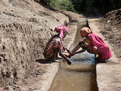 Niñas en un canal que riega cultivos en una comunidad rural en Etiopía, mediante paneles solares que ayudan a bombear el agua.