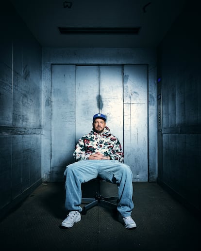 Residente poses in the building's elevator.