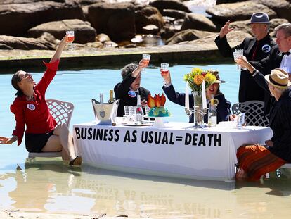 Climate activists from Extinction Rebellion stage a piece of street theatre on Water Day during COP27, to highlight the fact that fossil fuel "Business as Usual " is leading to climate disasters, such as sea level rise in Cape Town, South Africa, November 14, 2022. REUTERS/Esa Alexander