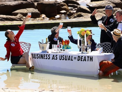 Climate activists from Extinction Rebellion stage a piece of street theatre on Water Day during COP27, to highlight the fact that fossil fuel "Business as Usual " is leading to climate disasters, such as sea level rise in Cape Town, South Africa, November 14, 2022. REUTERS/Esa Alexander