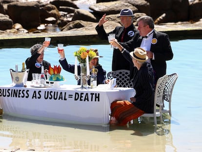 Climate activists from Extinction Rebellion stage a piece of street theatre on Water Day during COP27, to highlight the fact that fossil fuel "Business as Usual " is leading to climate disasters, such as sea level rise in Cape Town, South Africa, November 14, 2022. REUTERS/Esa Alexander