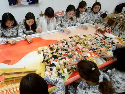 Mujeres chinas elaboran un mural para la celebración del día internacional de la mujer en Yangzhou, al este de China el 6 de marzo.