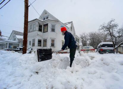 Rocio Franco shovels snow from the open of her driveway on Saturday, March 4, 2023, in Bellow Falls, Vermont.