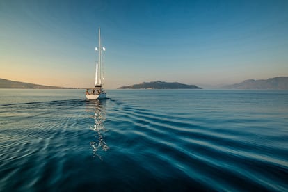 Lonely yacht sailing on silent sea. Aegina Island, Greece