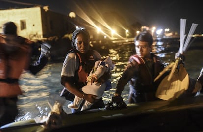 Una mujer junto a su bebé se sube en una lancha para intentar llegar a la isla griega de Kos desde la costa turca en Bodrum. Casi 2.000 refugiados sirios que fueron llevados en ferry desde la isla griega de Kos hacia el puerto de Salónica, en el norte del país, serán trasladados en autobuses hasta la frontera entre Grecia y Macedonia.