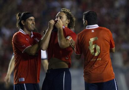 BAS201. BUENOS AIRES (ARGENTINA), 26/12/2013.- Gabriel Milito besa la camiseta a Alejandro Domínguez (i).